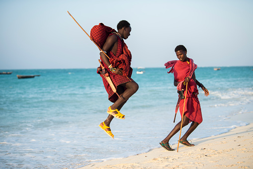 Zanzibar, Tanzania - 01,04,2019 : Masai warriors dressed in traditional clothes on Pongwe Bay sand beach of Zanzibar island