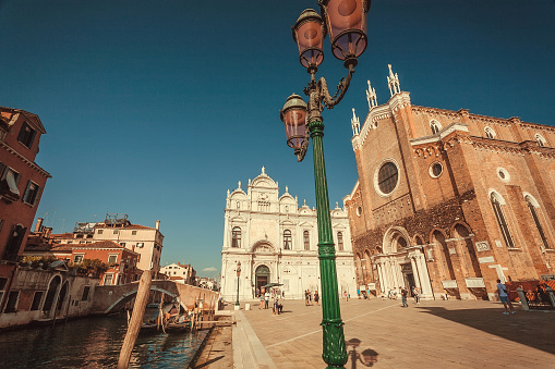 Venice, Italy:  Churches, bridges and lanterns around beautiful square Campo Santi Giovanni e Paolo on 29 September 2021. Ancient italian city and lagoon are UNESCO World Heritage Sites