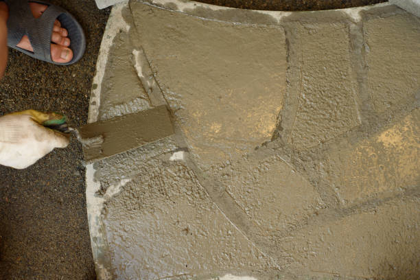 istock A man makes paving slabs from cement mortar using a form and a trowel 1353412148