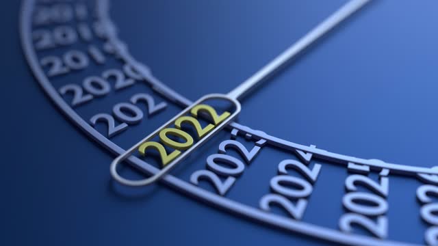 New Year 2022 is selected on a modern metal calendar against blue background. 4K Resolution.