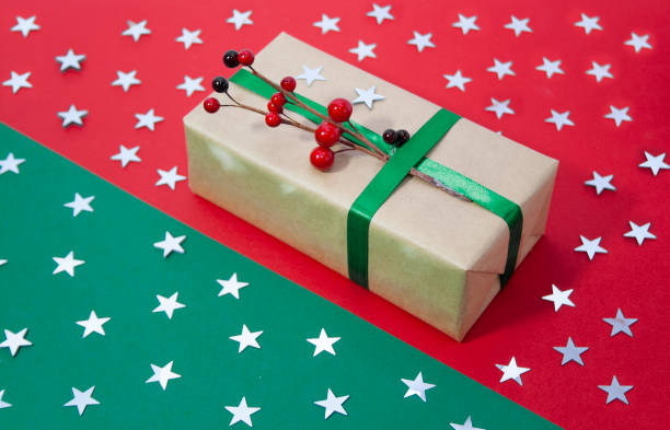 istock Christmas stars on a red green background with a gift 1353415338