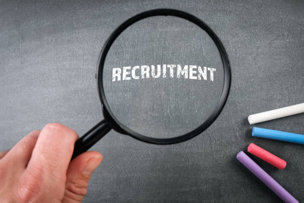 istock Recruitment, Business Concept. Magnifying glass on the board 1353415996