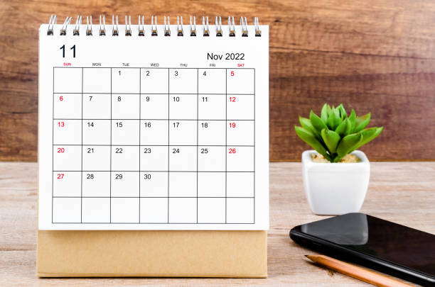 istock November 2022 desk calendar on wooden table. 1353416148