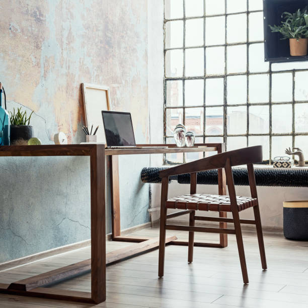 istock Stylish loft interior design. Open space. Home decor. Wooden table, desk with design accessories. Template. 1353416169