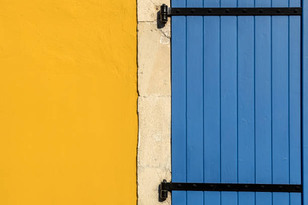 Close-up of yellow stone wall with blue wooden door