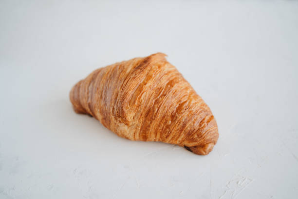 Plain croissant on white table. French pastry Plain croissant on white background. French pastry Plain Croissant stock pictures, royalty-free photos & images