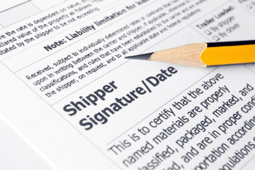 Paper with the shippers signature section with a pencil
