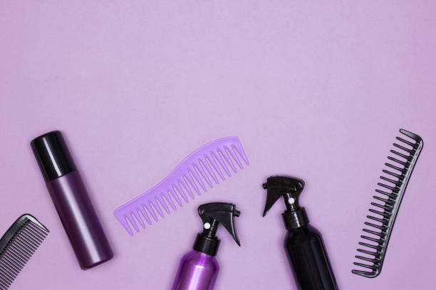 istock Hair styling products with combs top view on purple background. Copy space 1353420365