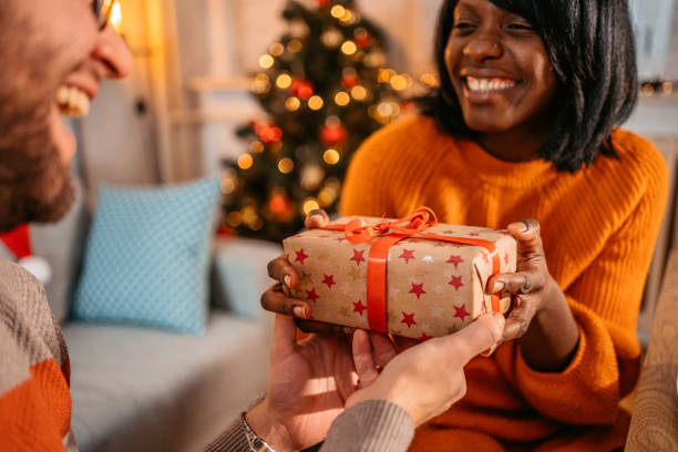 istock Girlfriend giving a present to her boyfriend 1353422495