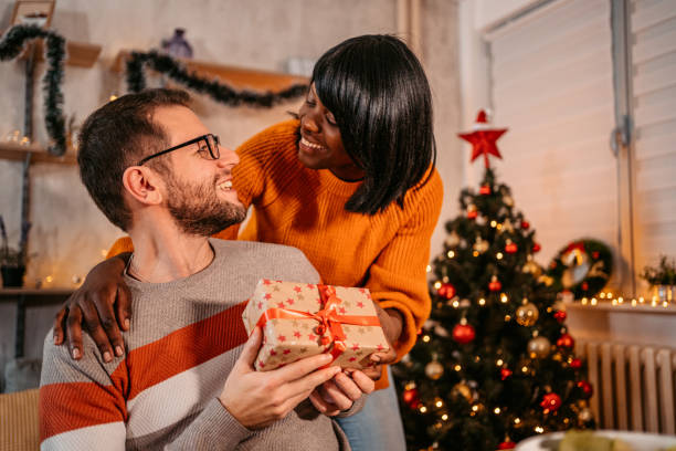 istock Girlfriend giving a present to her boyfriend 1353423232