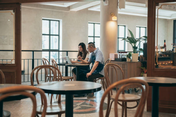 istock Young cafe owners planning about their business development 1353423259