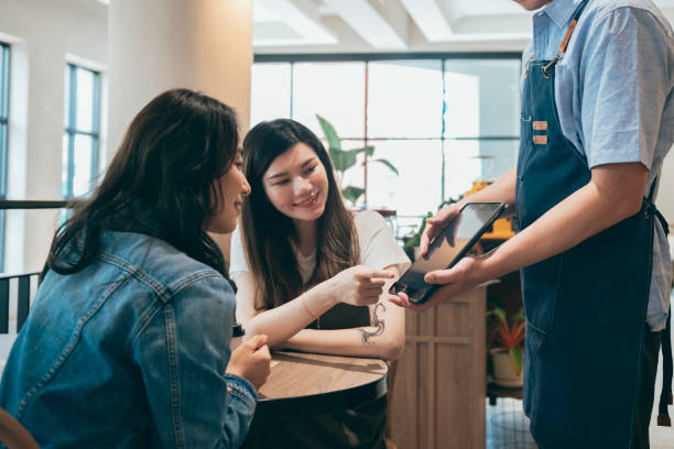 istock cafe owner using a digital tablet to show the menu to a custom 1353423277