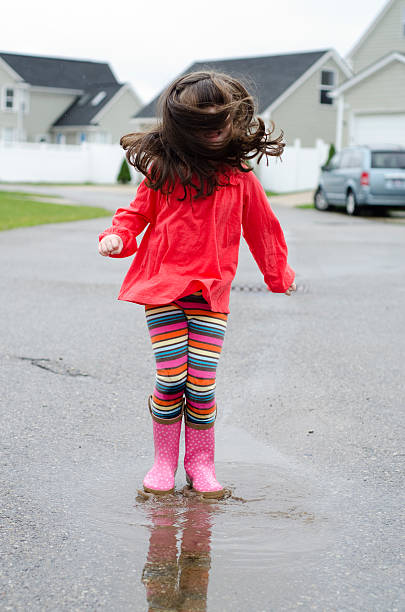 istock jumping in rain puddes with crazy hair 135342354