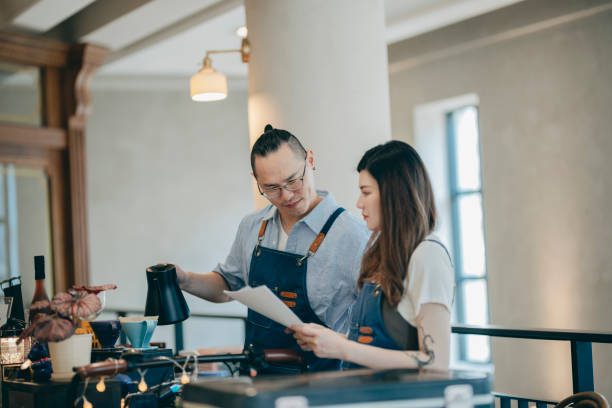 istock Young cafe owners planning about their business development 1353424154