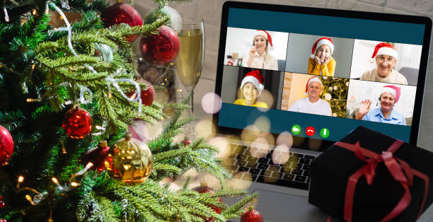 istock laptop with gift box and christmas lights background. 1353424273