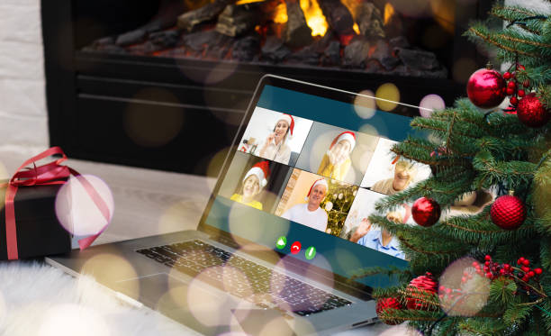 istock Virtual Christmas day house party. video conferencing Young man having video call via computer in the home office Online team gift opening conference calling. 1353424932