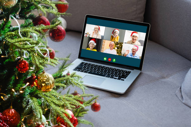 istock laptop with gift box and christmas lights background. 1353425497