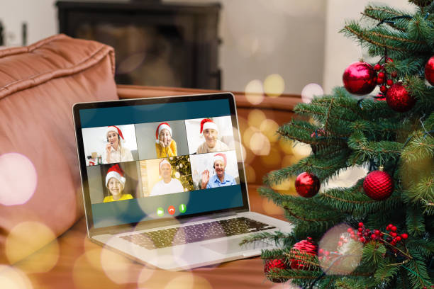 istock laptop with gift box and christmas lights background. 1353425583