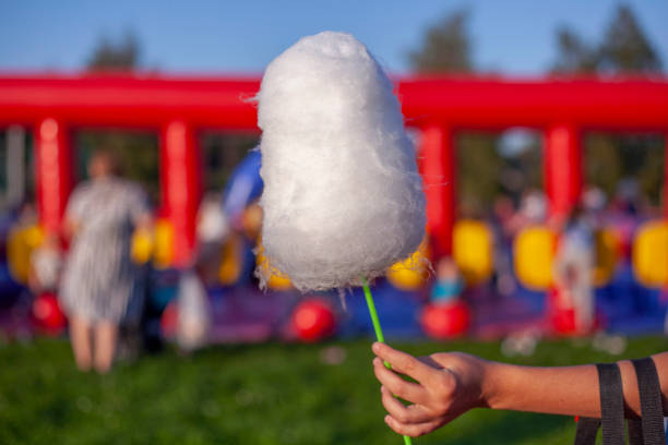 istock Cotton candy on stick. Sweetness on street. 1353425687