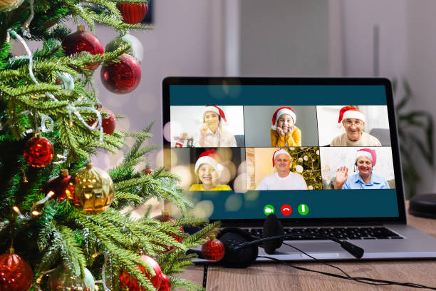 istock Virtual Christmas day house party. video conferencing Young man having video call via computer in the home office Online team gift opening conference calling. 1353426940