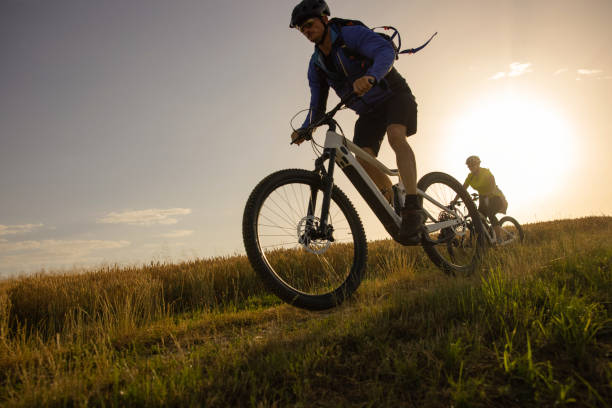 istock Couple riding bicycle downhill 1353428227