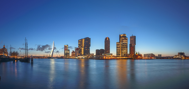 Rotterdam, Netherlands, city skyline on the river at twilight.