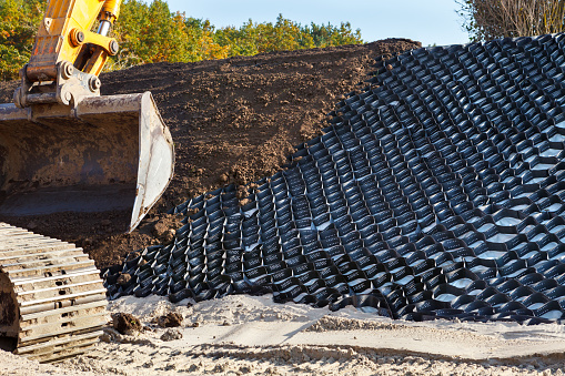 Polymer geogrid for filled with soil. Protection of sandy slopes with a geogrid