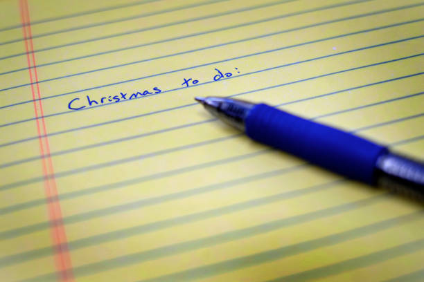 istock Written Christmas to do list on notebook paper and pen 1353436250