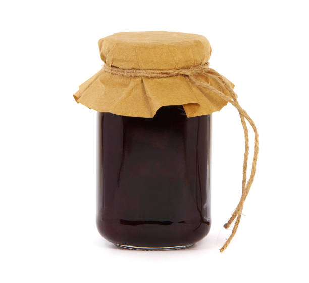 istock Plum jam in a glass jar isolated on white 1353436951