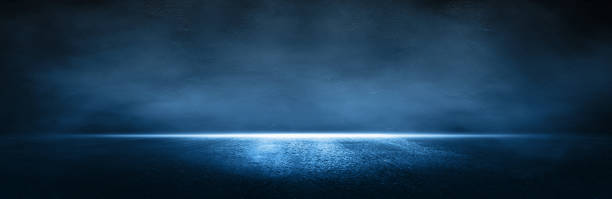 istock Rays, spotlights light.Empty dark scene with light.Asphalt blue dark street with smoke. 1353438433