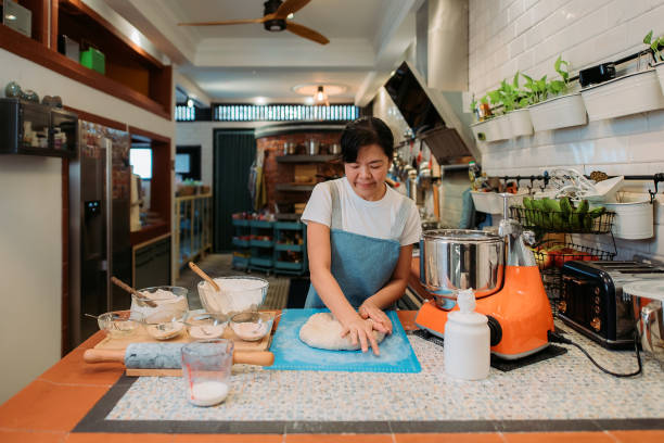 istock Asian chinese smiling baker women preparing dough in the kitchen 1353438507