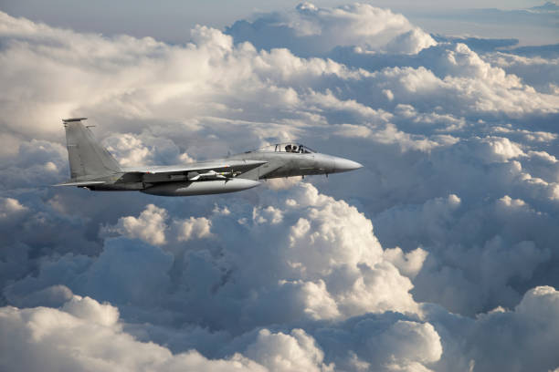 istock F-15 Fighter Jet flying over clouds 1353438827