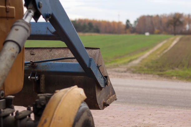 istock Old tractor driving to the field 1353438878