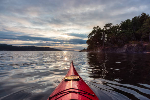 istock Sea Kayak paddling in the Pacific Ocean. Dramatic Sunset Sky. 1353441409
