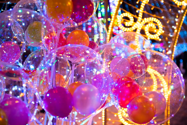 istock Christmas inflatable balls, decorations with lights. Abstract festive background.Festive multicolored balloons. Colorful holiday decor with balls. New Year, Christmas decoration, inflatable balls. 1353441780