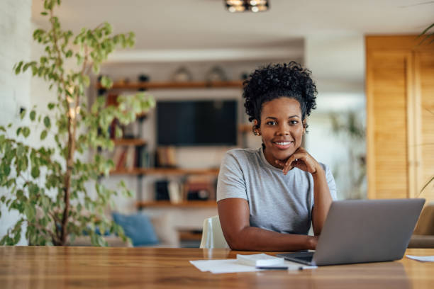 istock African-american woman, completing her application 1353442709