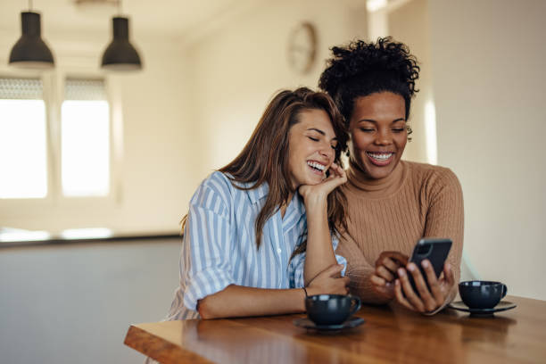istock Two diverse, happy partners, making a self portrait 1353442938