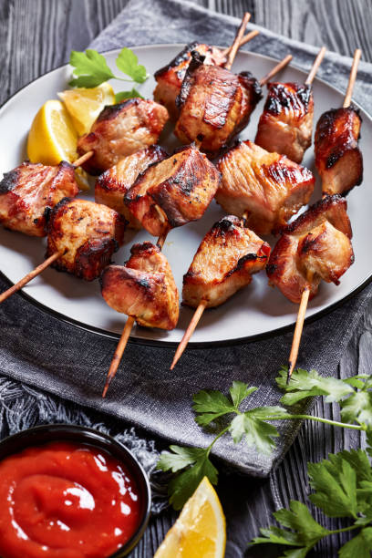 istock Juicy grilled pork kebabs on a plate with lemon wedges 1353443128