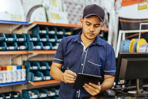 istock Young latin man working in hardware store 1353444468