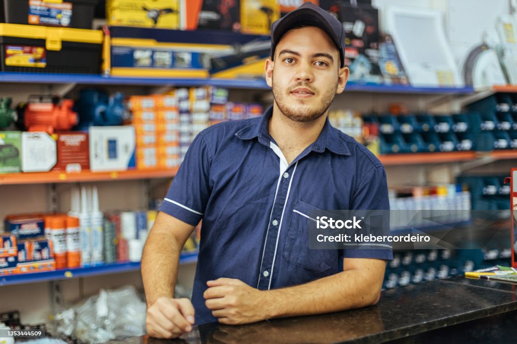 Young latin man working in hardware store Sales Occupation Stock Photo
