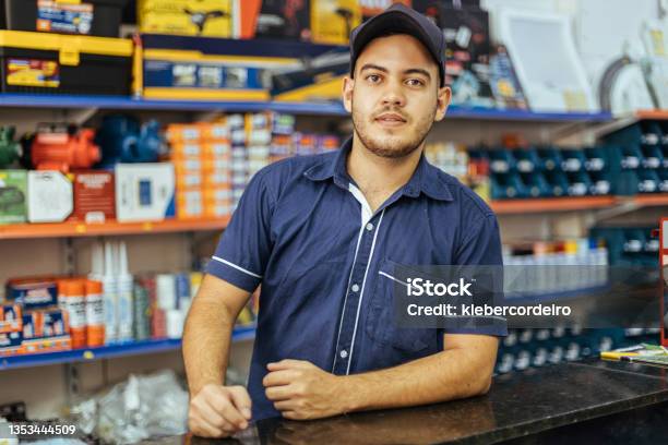 Young Latin Man Working In Hardware Store Stock Photo - Download Image Now - Sales Occupation, Business, Retail Clerk