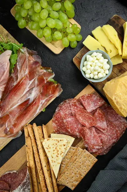 Appetizers table with italian antipasti snacks. Cheese and charcuterie variety board