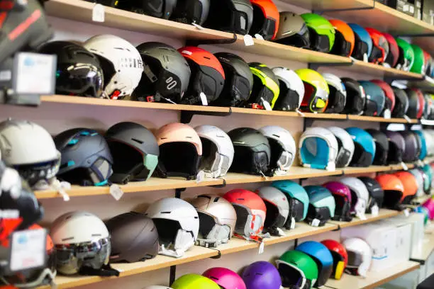 Sport store interior with rows of multi-colored skiing helmets