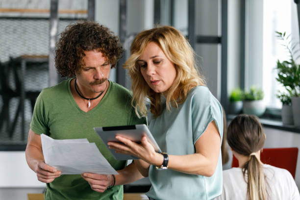 istock Business colleagues reviewing project data on digital tablet 1353446037