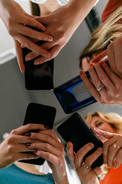 istock Four businesswomen using their smart phones 1353446468