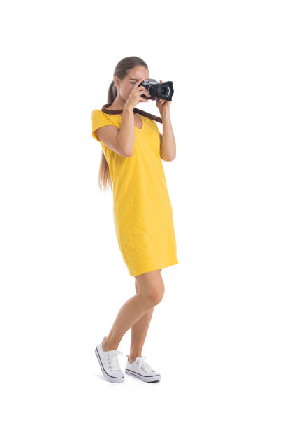 Young woman takes images with photo camera stock photo