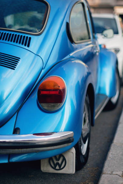 rear view of blue colored volkswagen brand and vw1303 model german product car on the street. - beetle imagens e fotografias de stock