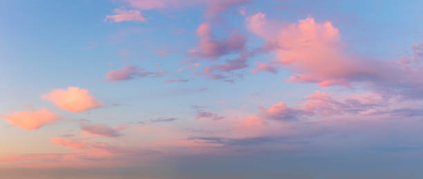 istock Pastel Light pink clouds in the blue sky during dawn sunset, sundown backgroung 1353448244