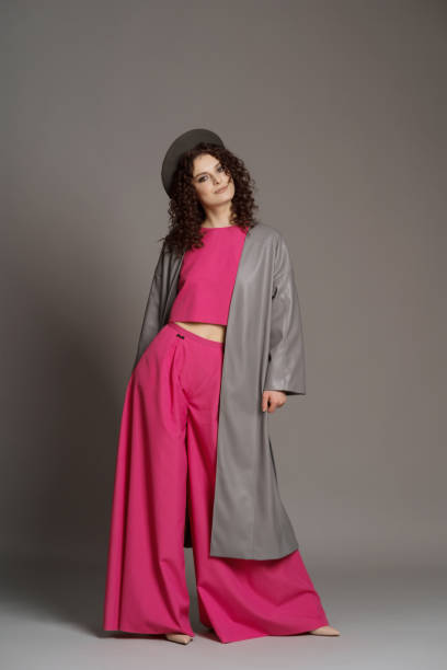 istock Woman in colorful clothes on studio gray background 1353450791