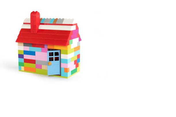 istock Colorful house made with toy from plastic blocks. Space for text. 1353451380